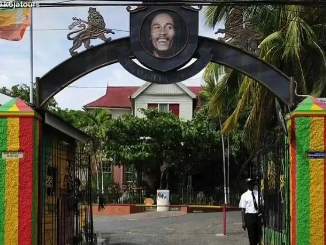 Entrance gate to the Bob Marley Museum with his portrait above.